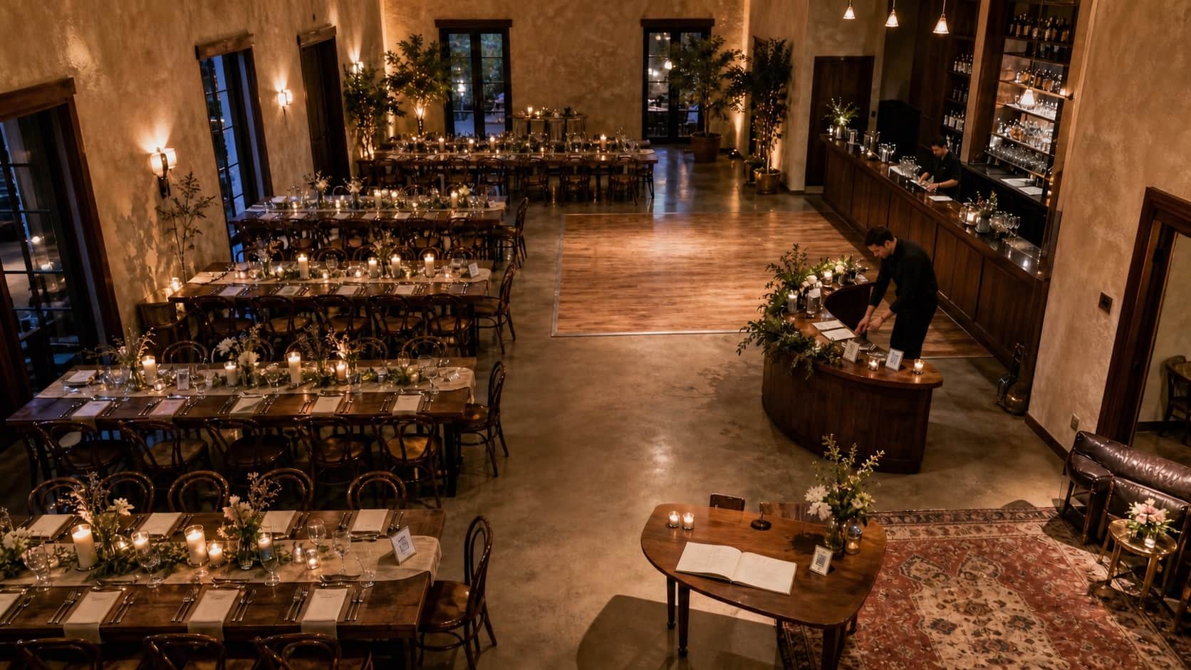 An elevated view of a wedding reception showing tables, bar, dance floor and guestbook placement zones